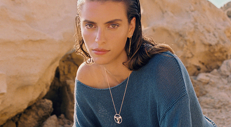 woman model with blue top looking at the camera wearing ANNOORY necklace